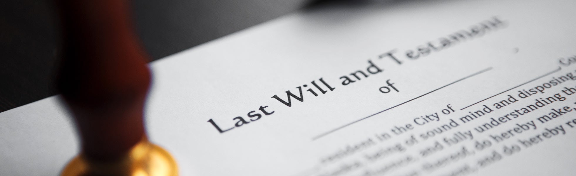 A close-up of a 'Last Will and Testament' document.