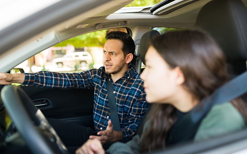 couple arguing in car.