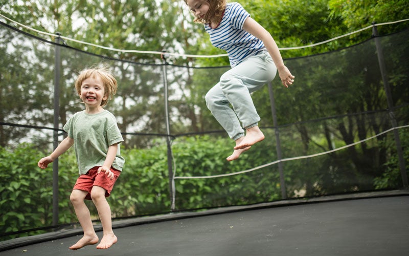 kids playing on trampoline.
