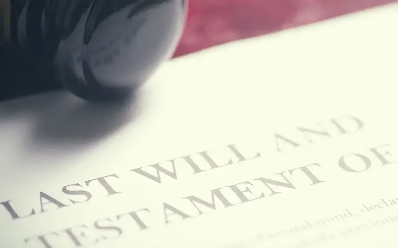 A Gavel rests on a document titled 'LAST WILL AND TESTAMENT OF'